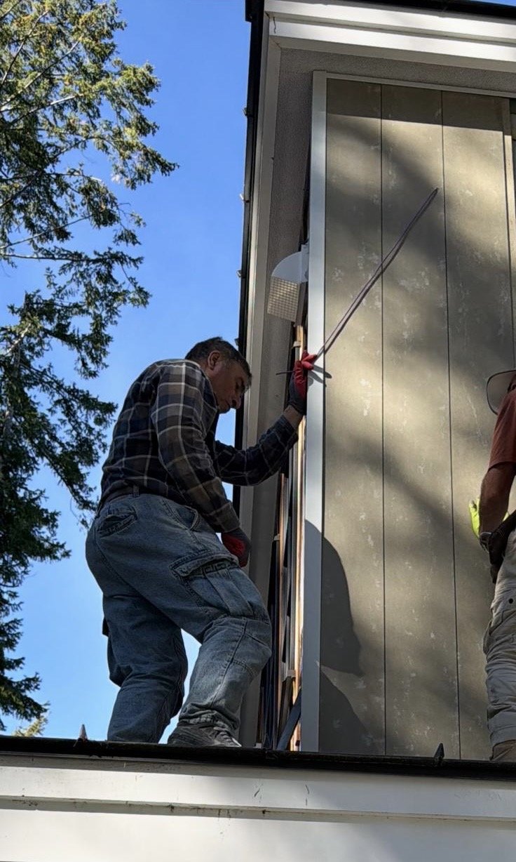 Can-Kos Siding crew installing exterior panel siding and trim on a Vancouver home