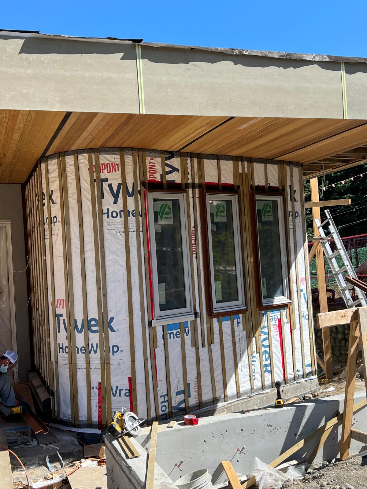 Curved exterior wall with strapping and house wrap before siding installation