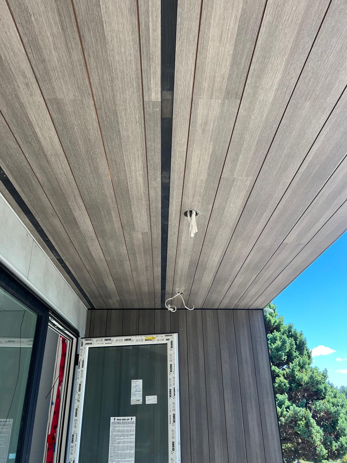 Finished Trespa soffit ceiling with black reveals and recessed lights